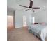 Bedroom boasts neutral carpet, a tray ceiling with ceiling fan, a window, and a decorative nightstand at 8623 Cedar Hollow Ln, Huntersville, NC 28078
