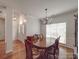 Open-concept dining room with classic furniture and hardwood flooring, adjacent to the foyer at 8623 Cedar Hollow Ln, Huntersville, NC 28078