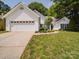 Inviting one-story home with lush lawn, a two-car garage, and manicured landscaping at 8623 Cedar Hollow Ln, Huntersville, NC 28078