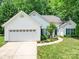 Charming single-story home with a two-car garage and a well-manicured lawn at 8623 Cedar Hollow Ln, Huntersville, NC 28078