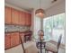 Eat-in kitchen features light wood cabinets, granite countertops, and a sun-filled breakfast nook with a glass table at 8623 Cedar Hollow Ln, Huntersville, NC 28078