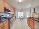 Well-lit kitchen featuring stainless steel appliances and an adjacent dining area at 8623 Cedar Hollow Ln, Huntersville, NC 28078