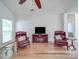 Cozy living room featuring two plush chairs and entertainment center at 8623 Cedar Hollow Ln, Huntersville, NC 28078