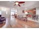 Open-concept living room and kitchen with hardwood floors and ample natural light at 8623 Cedar Hollow Ln, Huntersville, NC 28078