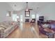Bright living room boasts hardwood floors, a fireplace, and a ceiling fan at 8623 Cedar Hollow Ln, Huntersville, NC 28078