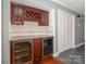 A custom bar area features glass-front refrigerators and a wine rack at 867 Southwest Dr, Davidson, NC 28036
