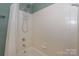 Bathtub and shower combination with tile walls, a shower head, and shower caddy at 867 Southwest Dr, Davidson, NC 28036