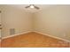 Empty bedroom featuring hardwood floors, a ceiling fan, and neutral-colored walls at 867 Southwest Dr, Davidson, NC 28036