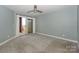 Spacious bedroom with neutral carpet and access to a private balcony at 867 Southwest Dr, Davidson, NC 28036