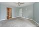 Bright bedroom with neutral carpet and easy access to an adjacent bathroom at 867 Southwest Dr, Davidson, NC 28036