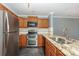 Spacious kitchen with stainless steel appliances, granite counters, and ample cabinet space at 867 Southwest Dr, Davidson, NC 28036