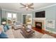 Cozy living room featuring a fireplace, lake views, and sliding glass door access at 867 Southwest Dr, Davidson, NC 28036