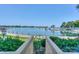 Picturesque patio view of the lake through a charming garden gate and manicured greenery at 867 Southwest Dr, Davidson, NC 28036