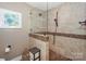 Tiled walk-in shower with glass enclosure and updated fixtures at 867 Southwest Dr, Davidson, NC 28036