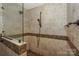 Tiled walk-in shower with glass enclosure and convenient hand-held shower head at 867 Southwest Dr, Davidson, NC 28036