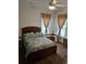 Bedroom with ceiling fan, dresser, and large windows at 9535 Potter Rd, Matthews, NC 28104