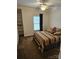 Bedroom with ceiling fan, window, and ample closet space at 9535 Potter Rd, Matthews, NC 28104