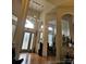 Welcoming foyer with soaring ceilings, wood floors, and modern lighting fixtures at 9535 Potter Rd, Matthews, NC 28104