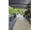 View of a covered patio with outdoor seating and an outdoor kitchen with granite counter tops and a grill at 9535 Potter Rd, Matthews, NC 28104
