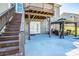 Spacious backyard patio with a gazebo, outdoor seating, and stairs leading to an upper deck at 9860 Darby Creek Nw Ave, Concord, NC 28027