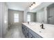 Bright bathroom featuring double sinks, white cabinets, and tiled floors at 9860 Darby Creek Nw Ave, Concord, NC 28027