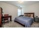 Bedroom featuring a large window, queen bed, and carpet flooring at 9860 Darby Creek Nw Ave, Concord, NC 28027