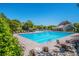 Large community pool with lounge chairs and tables surrounded by mature trees at 9860 Darby Creek Nw Ave, Concord, NC 28027