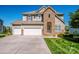 Charming two-story home with a well-maintained lawn and three-car garage, blending stone and siding details at 9860 Darby Creek Nw Ave, Concord, NC 28027