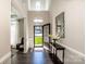 Elegant foyer with wood floors, high ceilings, decorative mirror, and an open view into other living spaces at 9860 Darby Creek Nw Ave, Concord, NC 28027