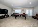 Spacious game room with a pool table, TV, and comfortable seating area at 9860 Darby Creek Nw Ave, Concord, NC 28027