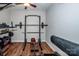 Home gym with weight training equipment, wood-look floors, and a ceiling fan at 9860 Darby Creek Nw Ave, Concord, NC 28027