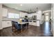 Modern kitchen with white cabinets, stainless steel appliances, black countertops, and a marble-topped dining table at 9860 Darby Creek Nw Ave, Concord, NC 28027
