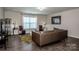 Bright living room with hardwood floors, neutral paint, and large window at 9860 Darby Creek Nw Ave, Concord, NC 28027