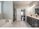 Stylish main bathroom with double sink vanity, soaking tub, and a glass-enclosed shower at 9860 Darby Creek Nw Ave, Concord, NC 28027