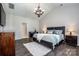 A spacious bedroom featuring a vaulted ceiling, a plush rug, and hardwood floors at 9860 Darby Creek Nw Ave, Concord, NC 28027