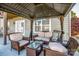 Relaxing covered patio area featuring comfortable seating and a glass-topped table at 9860 Darby Creek Nw Ave, Concord, NC 28027