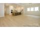 Spacious living room with open floor plan and large windows. Kitchen in background at 1019 Idyllic Ln, Waxhaw, NC 28173