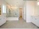 Bright bathroom featuring a marble shower, double vanity, and modern fixtures at 1019 Idyllic Ln, Waxhaw, NC 28173