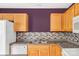 Bright kitchen shows the sink, countertop, mosaic backsplash, and wood cabinets at 1032 Eagles Nest Ln, Indian Land, SC 29707