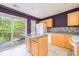 Well-lit kitchen with modern backsplash, an island and sliding glass doors to the deck at 1032 Eagles Nest Ln, Indian Land, SC 29707