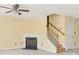 Bright and airy living room featuring a cozy fireplace and staircase at 1032 Eagles Nest Ln, Indian Land, SC 29707
