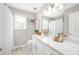 Well-lit bathroom with a white vanity, marble countertop, and updated fixtures at 11312 Fox Hill Dr, Charlotte, NC 28269