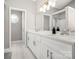 Modern bathroom featuring double sinks, a large mirror, and updated lighting at 11312 Fox Hill Dr, Charlotte, NC 28269