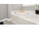 Relaxing bathtub nook with a soaking tub and natural light from a nearby window at 11312 Fox Hill Dr, Charlotte, NC 28269