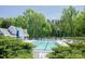 Community pool surrounded by ample seating and lush landscaping, perfect for summertime relaxation at 11312 Fox Hill Dr, Charlotte, NC 28269