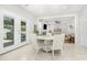 Bright dining area with white table set, leading to a cozy living room and a view outside at 11312 Fox Hill Dr, Charlotte, NC 28269