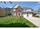 Beautiful two-story home with brick facade, blue shutters, and manicured lawn at 11312 Fox Hill Dr, Charlotte, NC 28269