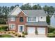 Charming two-story house featuring brick, light gray siding and a 2-car garage at 11312 Fox Hill Dr, Charlotte, NC 28269
