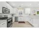 Bright kitchen features white cabinetry, stainless steel appliances, and modern countertops at 11312 Fox Hill Dr, Charlotte, NC 28269