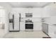 Modern kitchen features white cabinets and stainless steel appliances at 11312 Fox Hill Dr, Charlotte, NC 28269